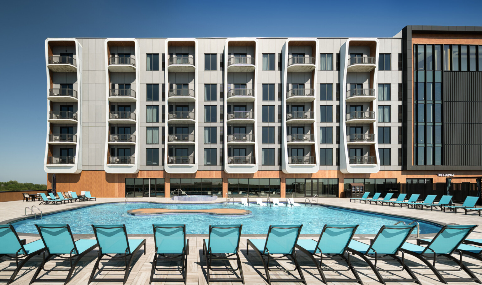 daytime view of Grand Island Casino Resort at Fonner Park rooftop pool deck and hotel tower.