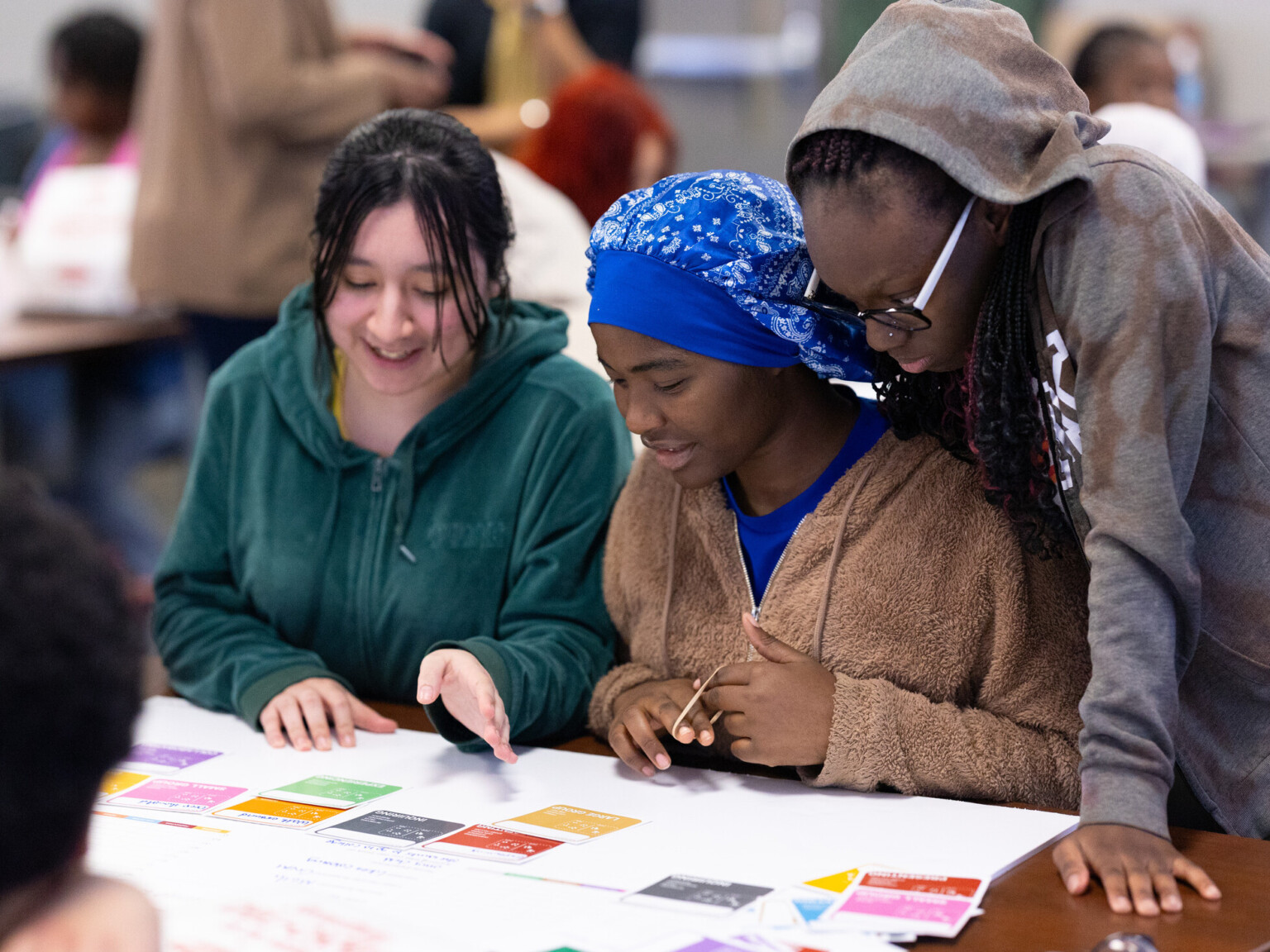 three students at a workshop for community engagement; student engagement and student-led design