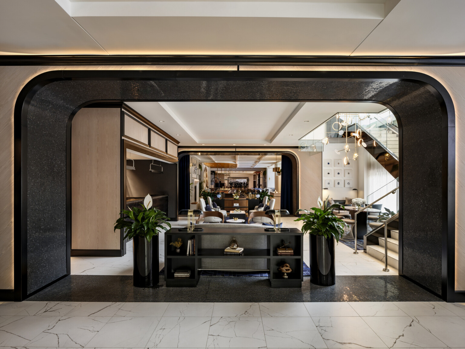 The Vanguard Hotel, Autograph Collection lobby; archway with seating and tables for guests; elegant dark and light wood for a modern but historical feel