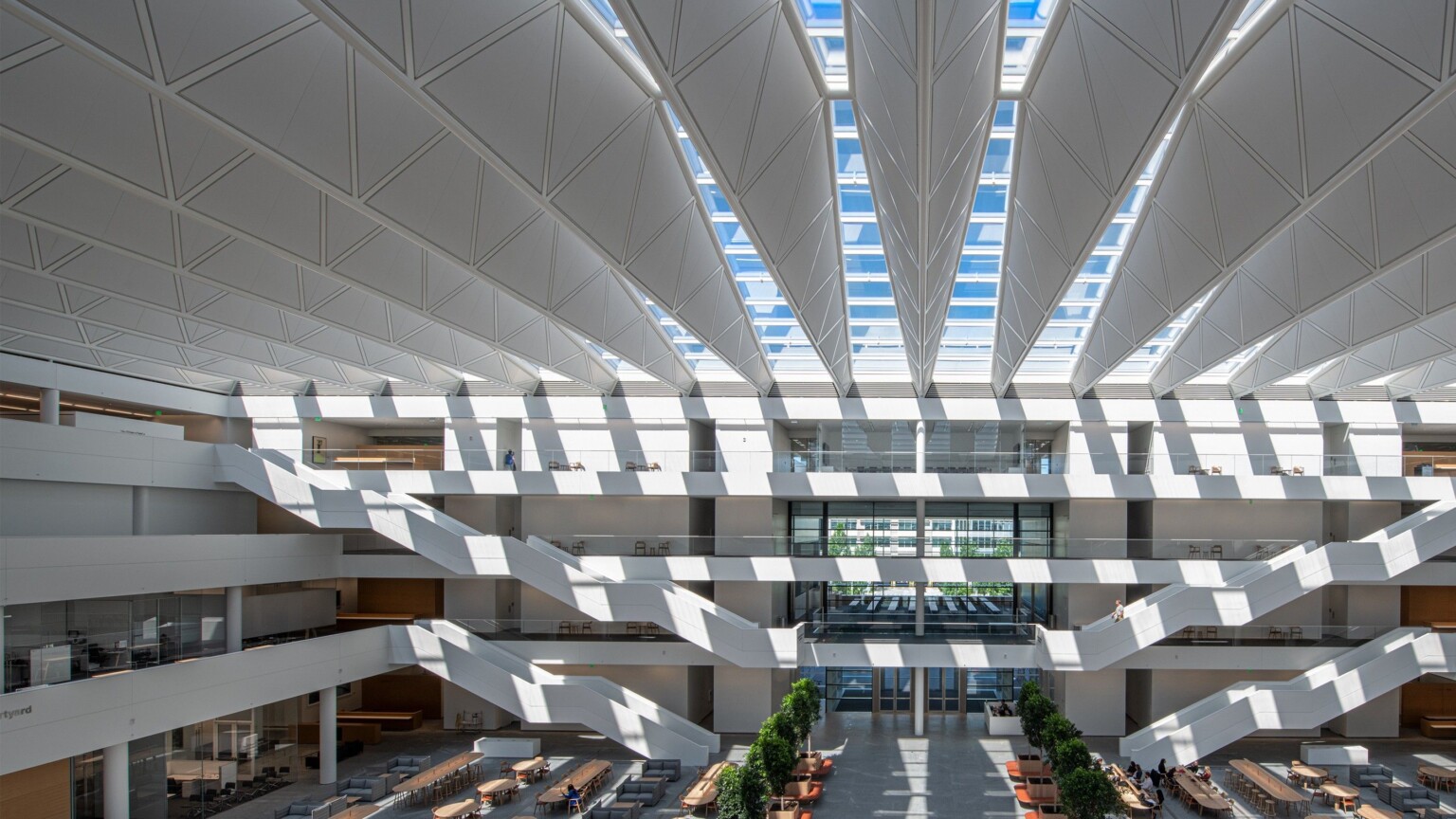 White atrium in 4 story Sheila and Eric Samson Pavilion Health Education Campus. White bannisters and walkways come to center