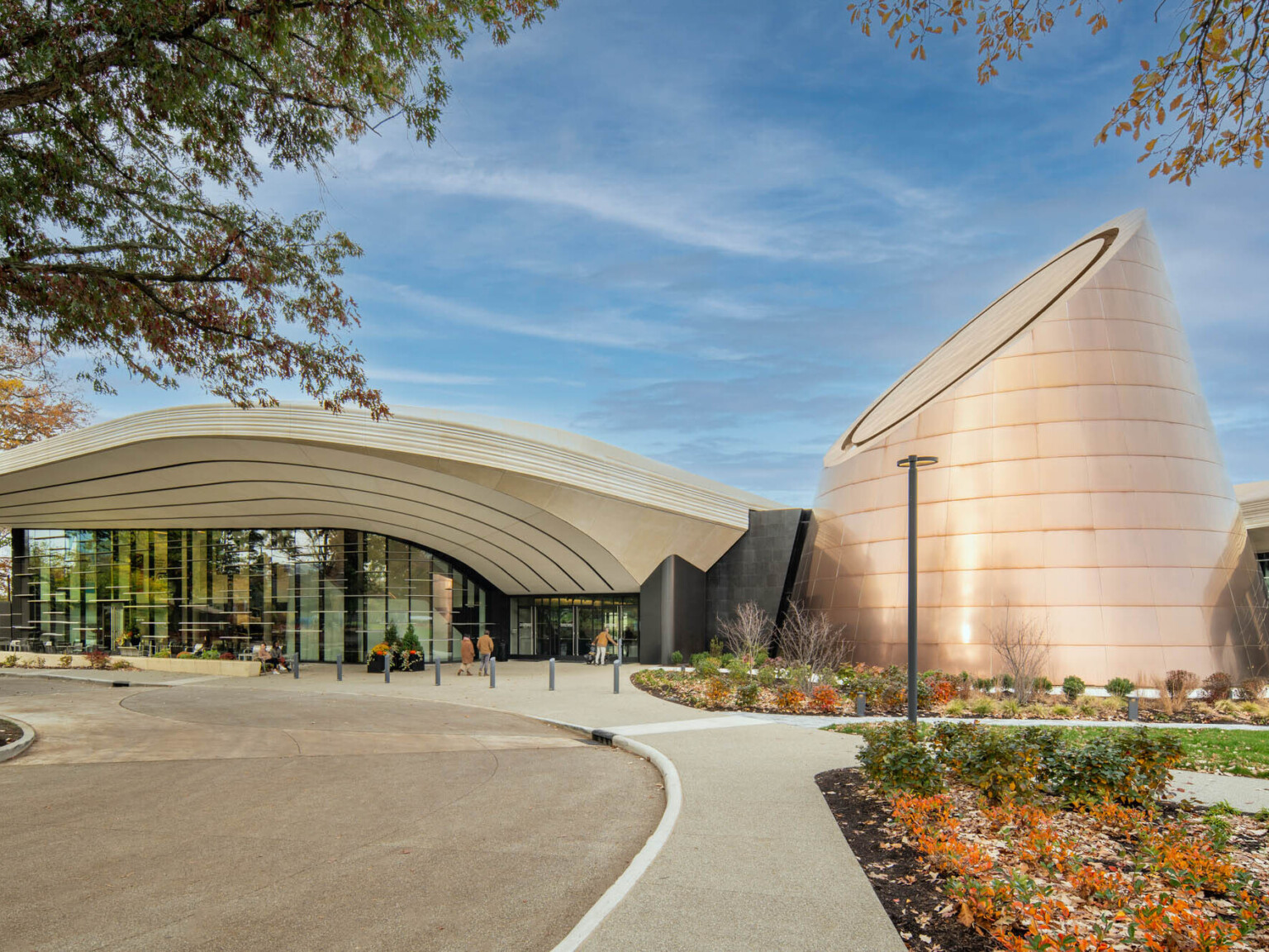 Modern building with a cone shaped tower surrounded by landscaping