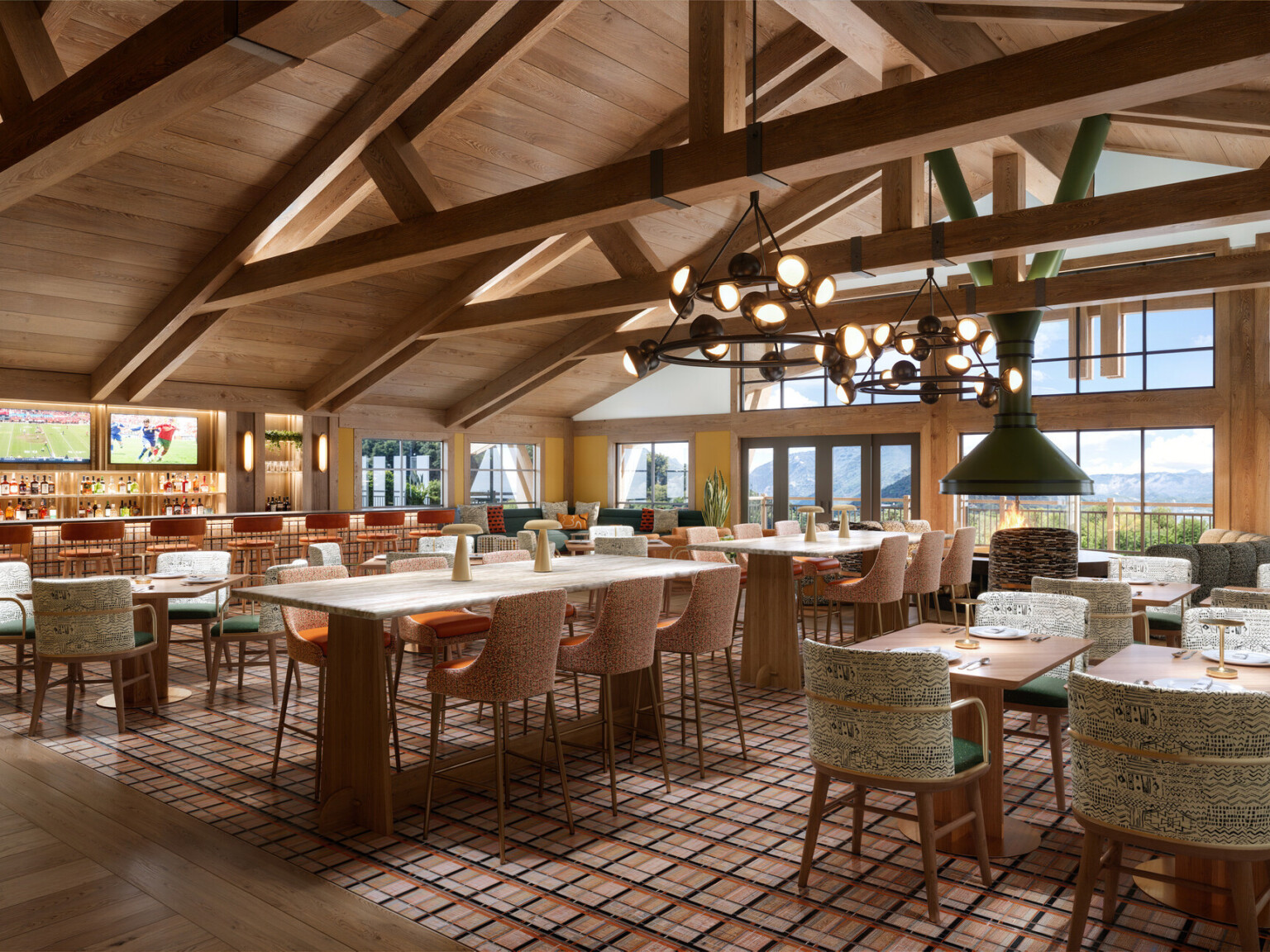 Canopy by Hilton, Park City, Utah dining room; timber and wood design throughout the space with vaulted ceilings and wood beams; cozy country style tables overlook a wall of windows to the mountain view; bar to the far left wall of the space with sports on the TVs