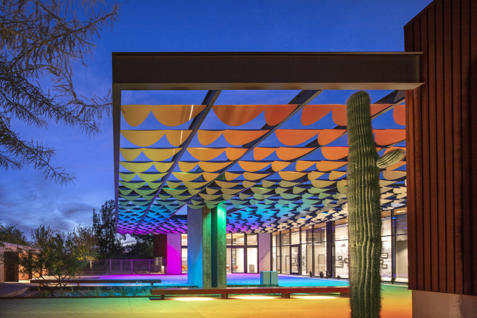 Infinite Shade art installation, colorful array of lights and metal pieces create a shading structure for passive cooling; dlr group design