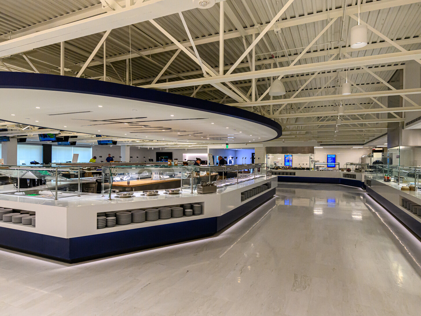 Penn State’s Greenberg Indoor Sports Complex dining space; large white buffet counter in the center of the room with similar counters on the perimeter of the space