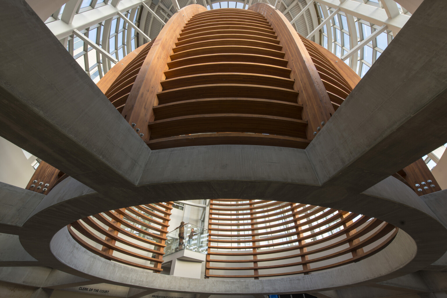wood grid sections curve into a rotunda with view of sky above at Pueblo County Judicial Center