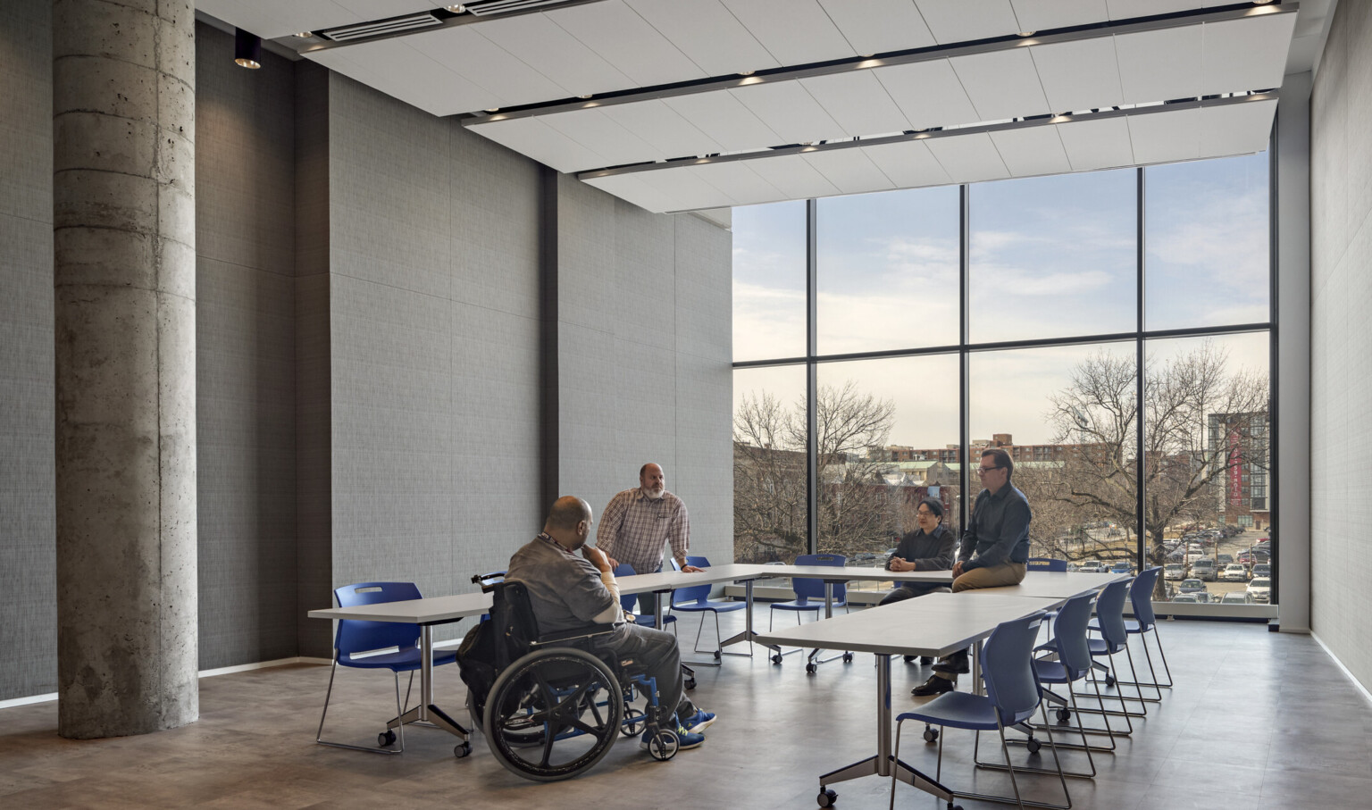 veterans sitting around table in a midrise home in Washington, D.C.; accessible furnishes for individual in wheelchair