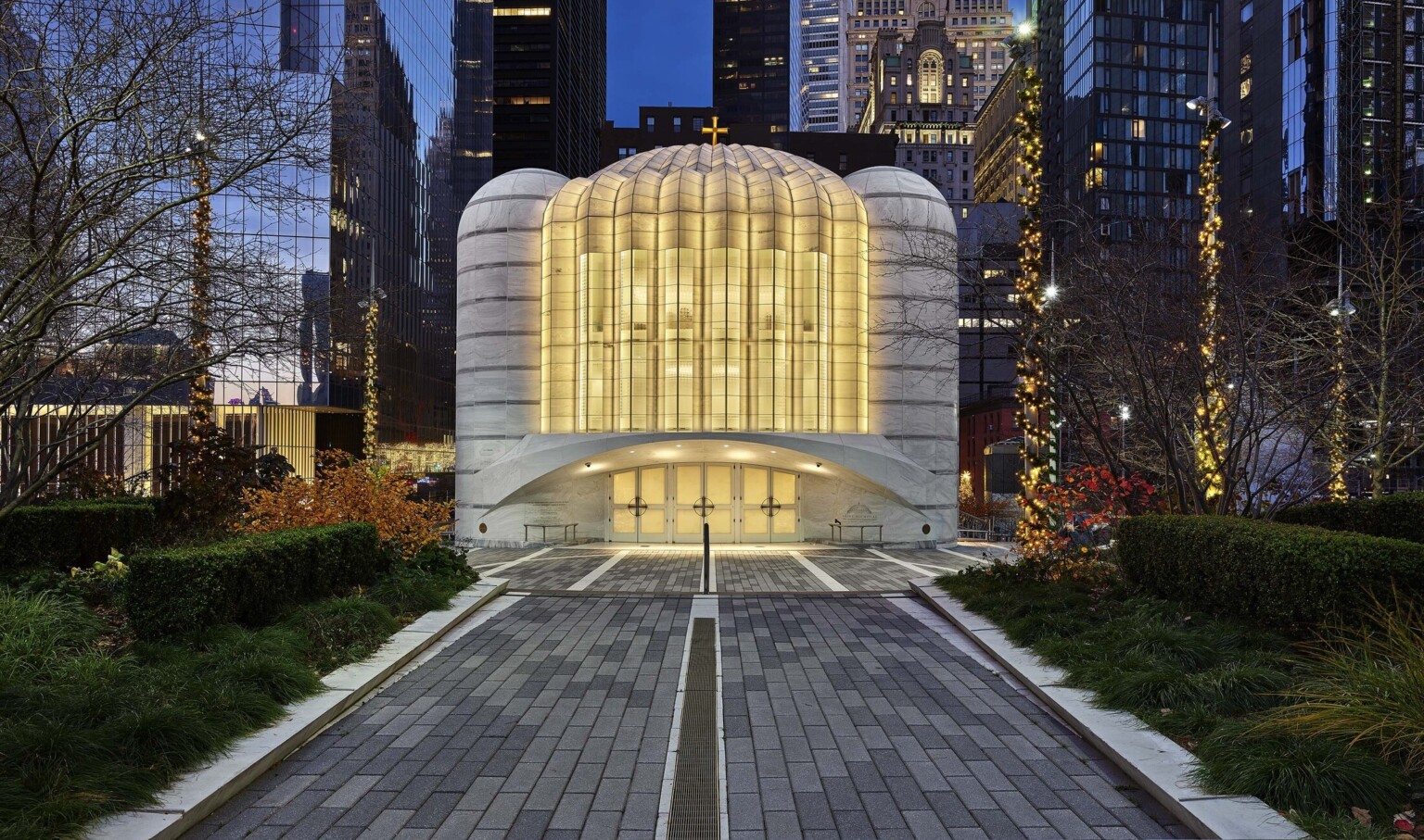 Saint Nicholas Greek Orthodox Church illuminated in the evening, a white and rounded building at the new World Trade Center in New York City