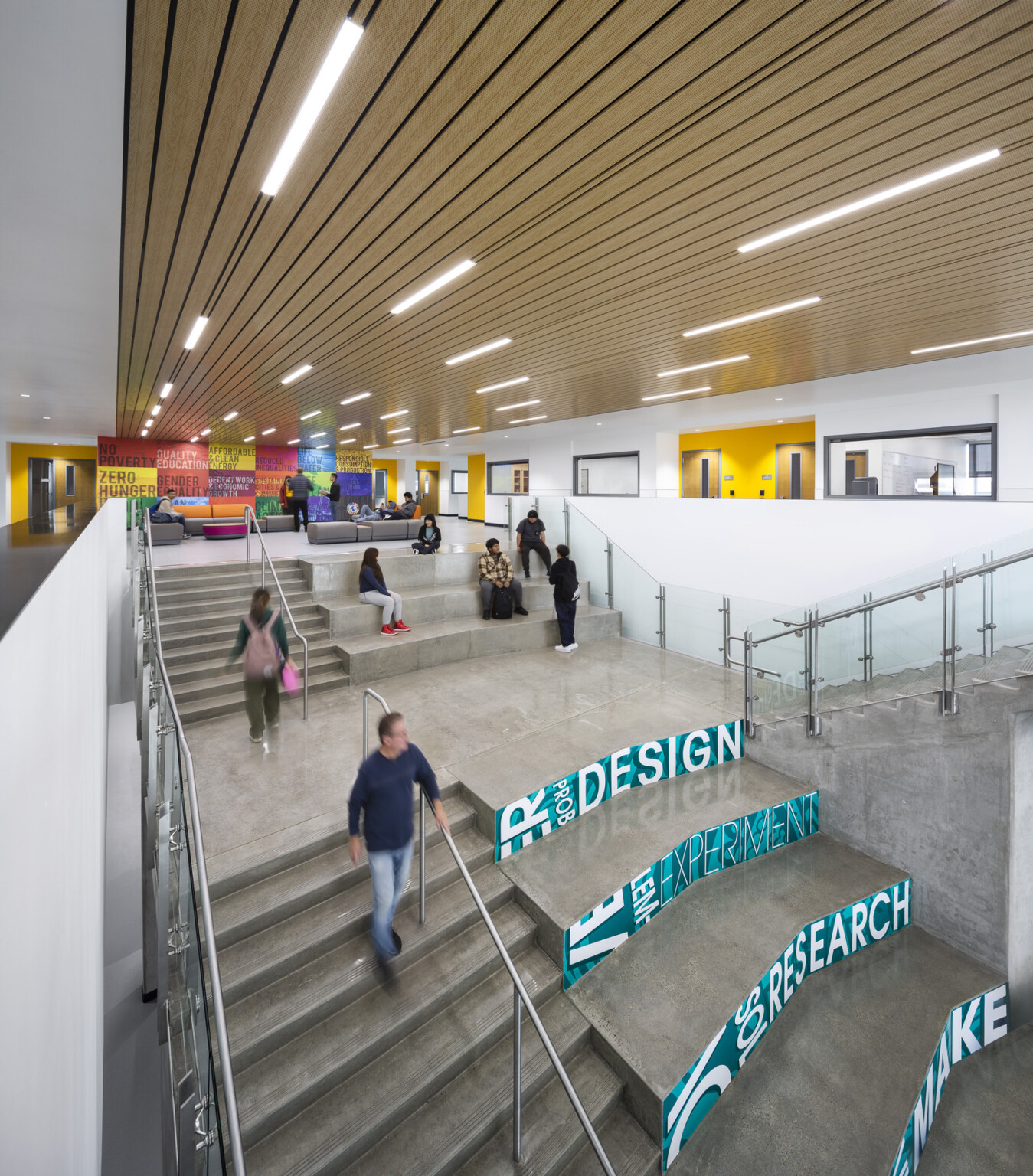 stairwell of Logan Memorial Educational Campus; bright blue and white letters facing the entry with “Discover” “Innovate” “Prototype” “Make” “Search” “Design”