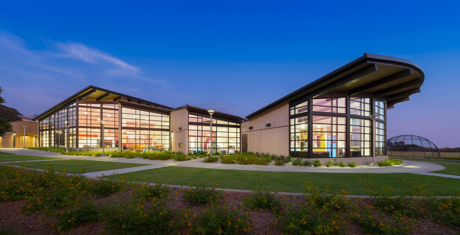 exterior of Del Mar Heights School at night, architecture inspired by California Coastal Architecture; indoor outdoor learning space with large openable windows