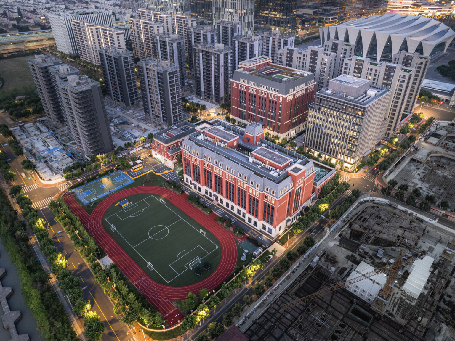 Huili School Shanghai; aerial image of an urban high school campus; center piece of the photo soccer field