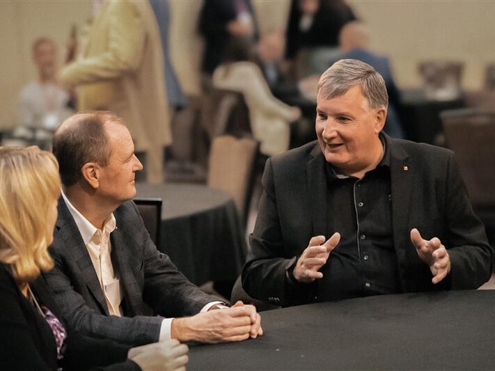 Lloyd Ramsey speaking with other people at at DLR Group event