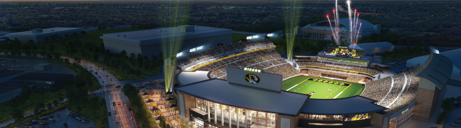 Night view of an illuminated football stadium with spectators and fireworks.